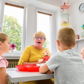 Children speech therapy concept. Children practicing correct pronunciation with a female speech therapist. Group therapy.