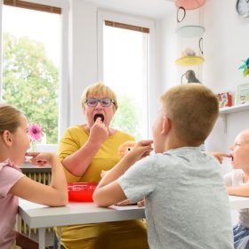 Children speech therapy concept. Children practicing correct pronunciation with a female speech therapist. Group therapy.