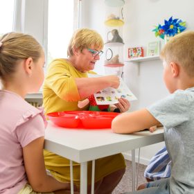 Child occupational therapy session. Group of children doing playful exercises with their therapist.