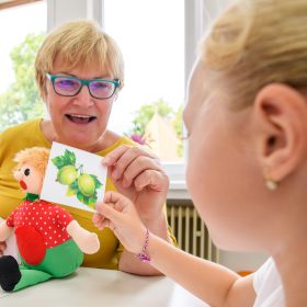 Children speech therapy concept. Preschooler practicing correct pronunciation with a female speech therapist.